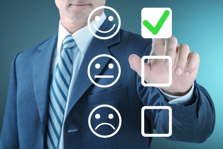 Businessman giving rating with happy icon Stock Photo