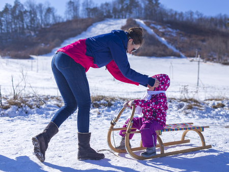 outdoor fun for family christmas vacation little girl enjoying a sleigh ride child sledding children play outdoors in snow - Christmas Vacation Sled outdoor fun for family christmas vacation little girl enjoying a sleigh ride child sledding children play outdoors in snow - Christmas Vacation Sled