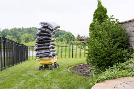 29655524-mulch-in-bags-piled-high-on-a-cart-in-the-garden-teetering-precariously-as-they-wait-to-be-spread-ov.jpg