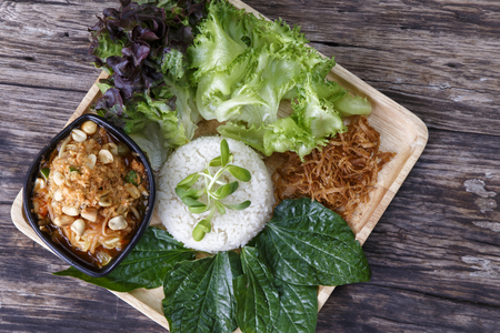 Asian food. Rice mixed with Coconut Cream With Papaya Salad (khao Man Som Tam) on wooden background