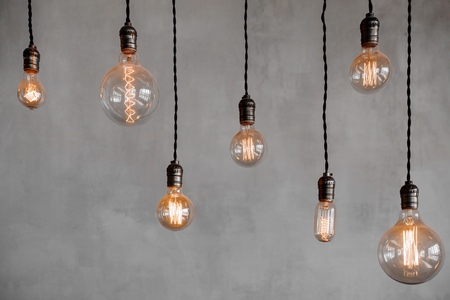edison retro lamp incandescent bulbs on gray plaster wall background