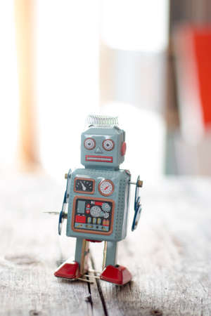 Robot toy symbol for a chatbot or social bot and algorithms wood texture Stock Photo