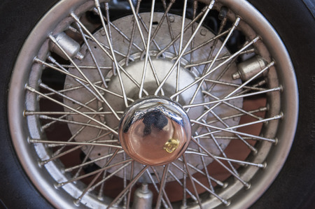 closeup detail of an old car tyre wheel with spokes stock photo