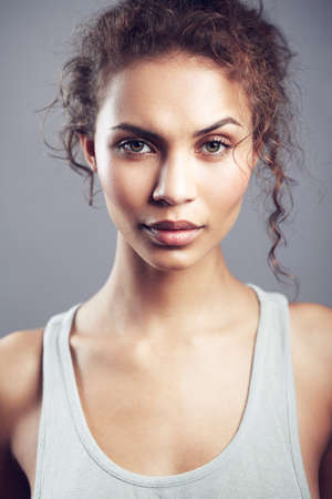 Gorgeous in all the right ways. studio shot of a gorgeous young woman posing against a gray background.