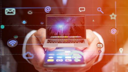 View of a businessman using a smartphone with a computer surrounding by app and social icon 3d render
