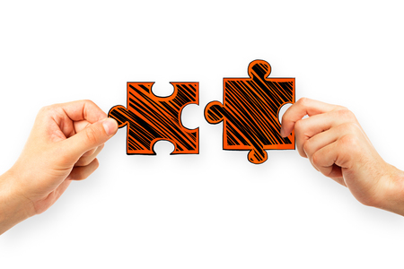 Hands with drawn puzzle pieces on white background. teamwork and challenge concept Stock Photo