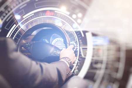 Back view of businessman at car wheel with abstract digital pattern. Future technologies concept