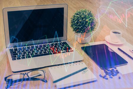 Double exposure of graph and financial info and work space with computer background concept of international online trading