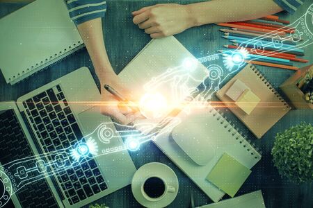 Double exposure of hands making notes with digital coding icons computer learning concept