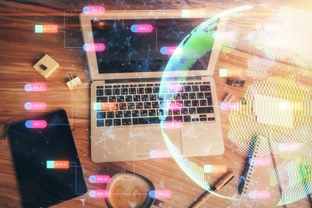 Double exposure of map hologram drawing over study table background with computer concept of international network top view Stock Photo