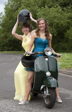 Girls In Party Dresses Ride A Motor Scooter Photo Girls In Party Dresses Ride A Motor Scooter Photo