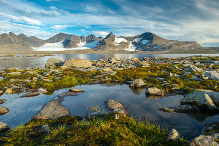 Rocky mountains with glaciers in last light of the day in the remote arctic wilderness of lapland. sarek national park,sweden.barddetjahkka,balgattjahkka,lullihatjahkka peaks, balgatjiegna glacier