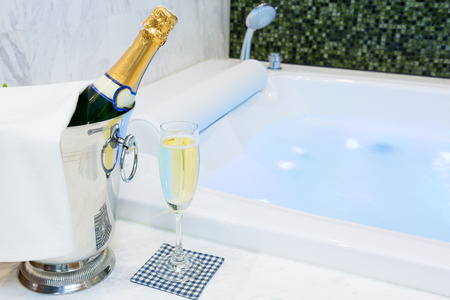 Champagne glass and jacuzzi spa with colourful light whirlpool stock ... Glass idromassaggio spa