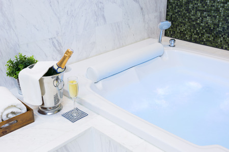 Champagne glass and jacuzzi spa with colourful light whirlpool stock ... Glass idromassaggio spa