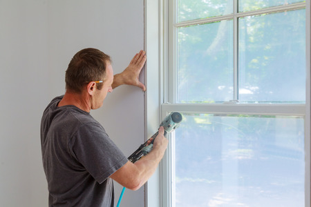 window framing trim wood carpenter using nail gun to moldings on windows framing trim with the warning that using nail gun to moldings on windows framing trim window framing trim wood carpenter using nail gun to moldings on windows framing trim with the warning that using nail gun to moldings on windows framing trim