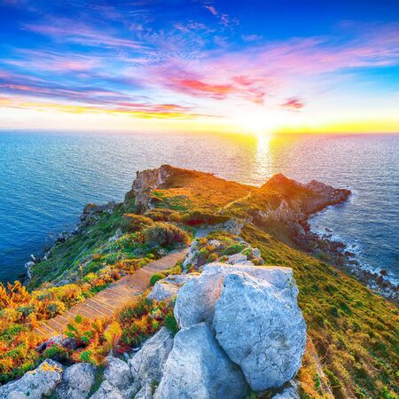 Dramatic spring sunset on the the cape Milazzo panorama of nature reserve Piscina di Venere.  Location: cape Milazzo,  Island Sicilia, Italy, Europe. Mediterranean and Tyrrhenian sea - 132019826