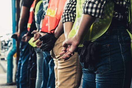 Factory workers standing in a row showing teamwork and unity labor and job concept