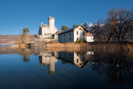 A Medieval Fairytale Castle At The Foot Of The French Alps Reflected In Lake Annecy With A Medieval Fairytale Castle At The Foot Of The French Alps Reflected In Lake Annecy With