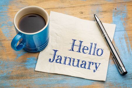 Hello january handwriting on a napkin with a cup of coffee Stock Photo