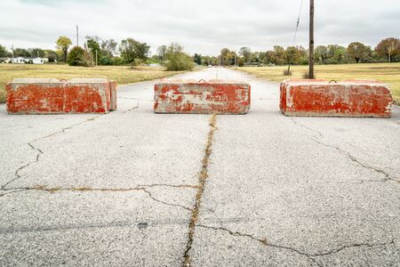 Heavy concrete roadblocks blocking highway or street. Obstacle, dead end  or obstruction to progress concept. Banco de Imagens