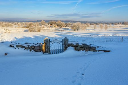 Snow Covered Gate In A Rural Winter Landscape