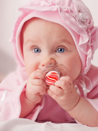 small cute baby holding a red dummy stock photo picture and royalty