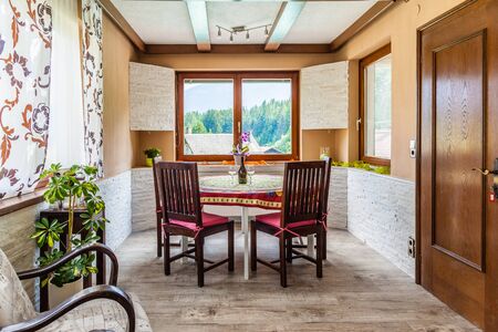 https://us.123rf.com/450wm/porpeller/porpeller1508/porpeller150800236/46338180-a-cozy-dining-room-with-a-table-and-two-glasses-of-whine-and-a-bottle.jpg?ver=6