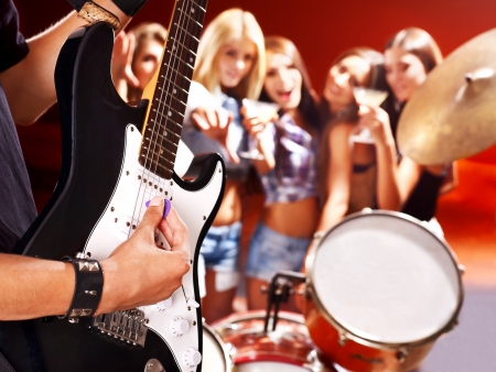 Woman beat guitar: Musical group playing in night club. Body part. Kho ảnh