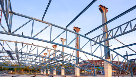Low angle view of metal roof structure on the ground for install on top of building structure in construction site. Banco de Imagens