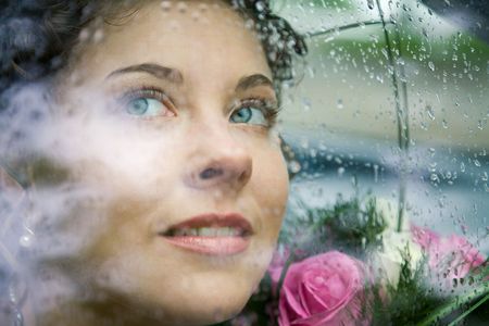 Photo of pretty face of bride through window of