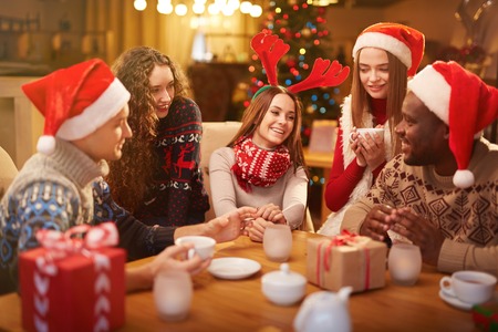 Young people celebrating christmas at home