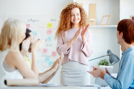 Positive colleagues applauding each other