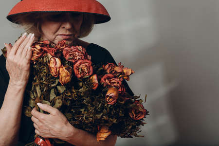 Upset Elderly Woman Hold Withered Dry Old Rose Flowers Bouquet