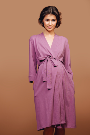 A portrait of a pregnant charming lady in studio. fashion concept. motherhood.