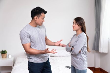 Unhappy Asian Couples standing beside each other and women avoid talking or quarrel, Cause of angry, quarrel, relationship problems and having misunderstanding or disagreement. Family problems concept Stock Photo