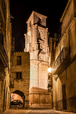 Christian church iglesia de la asunción in calaceite, vertical picture by night, calasseit, teruel, aragon, spain.