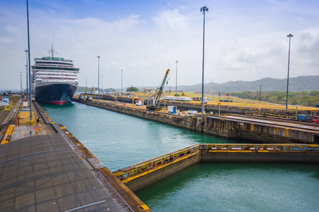 COLON, PANAMA - APRIL 15, 2015: The Queen Victoria navigating the Panama Canal, is classified as a Panamax vessel, the largest the canal can accommodate. Gatun Locks.