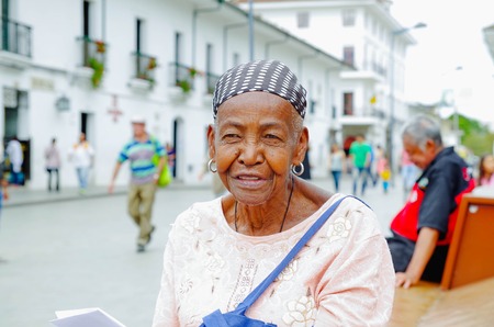 Popayan, colombia - february 06, 2018: portrait of gorgeous colombian black women smiling and looking somewhere, in the streets of popayan