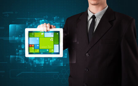 dolar: Young businessman holding a tablet with modern software operational system