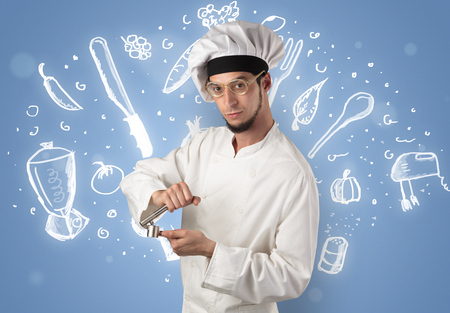 キッチン楽器と壁紙に描かれたレシピのコンセプトと若い料理人 の写真素材 画像素材 Image