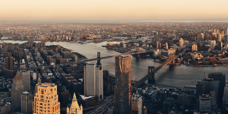 Manhattan downtown sunset rooftop panorama view with urban skyscrapers in new york city