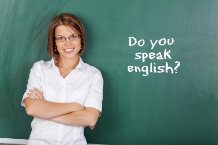 Cheerful woman teaching English class at the classroom Stock Photo