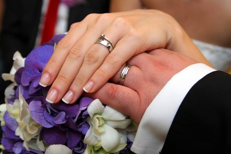 wedding ring hands bride and groom hands wearing wedding rings over bride bouquet - Wedding Rings On Hands wedding ring hands bride and groom hands wearing wedding rings over bride bouquet - Wedding Rings On Hands
