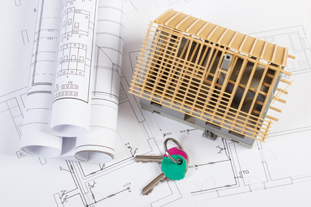 home keys small house under construction and rolls of diagrams on electrical drawings for project - Home Construction Diagram home keys small house under construction and rolls of diagrams on electrical drawings for project - Home Construction Diagram