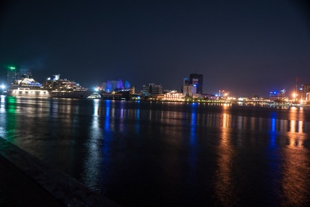 The landscape of Saigon: Cityscape of Ho Chi Minh at night with bright illumination of modern architecture, viewed over Saigon river in Southern Vietnam.
