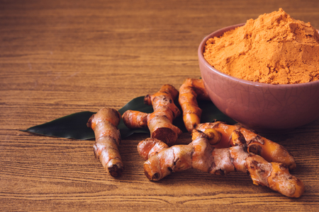 89728388-turmeric-roots-with-turmeric-powder-on-wooden-background-.jpg?ver=6