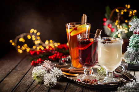 Fresh Yellow Eggnog, Grog And Fruity Red Mulled Wine With Christmas Decoration. Selection Of Autumn Or Winter Alcoholic Hot Drinks