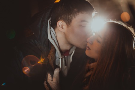 Happy pair loving each other in night park filtered photo with flash flare