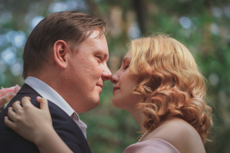 bride and groom on the background of trees and forest sun. Stock Photo