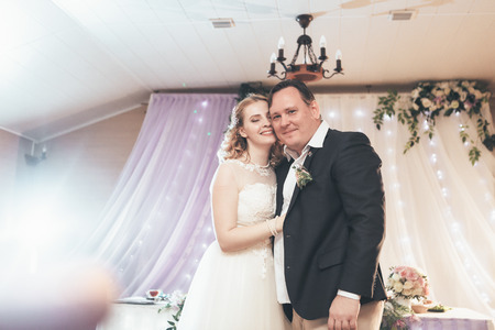 bride and groom first dancing on background a restaurant. Stock Photo